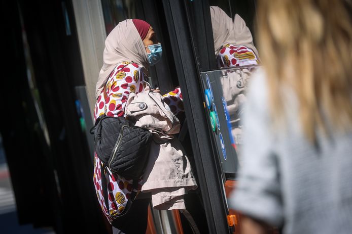 Illustratiebeeld. Een vrouw met hoofddoek in Brussel stapt in een bus van vervoersmaatschappij MIVB.