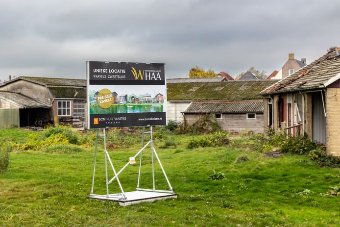 Het bouwbord kondigt de nieuwbouw aan op het voormalige fabrieksterrein.
