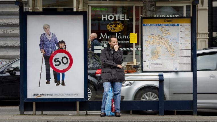 Een reiziger wacht bij een halte in Amsterdam in april tevergeefs op de bus. Het Amsterdamse vervoerbedrijf GVB voerde opnieuw actie tegen de kabinetsplannen met het stadsvervoer in de drie grote steden. © ANP Beeld ANP