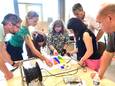 Medewerkers van de acht SKPOEL-scholen werken samen aan een kleurrijk kunstwerk.