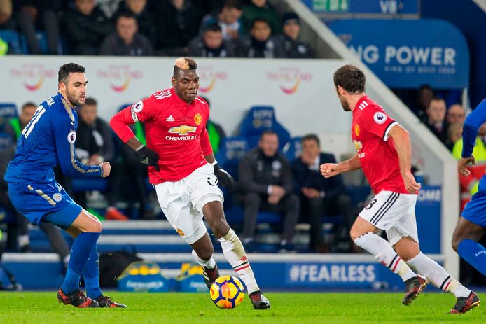 Manchester United's French midfielder Paul Pogba (C) goes past Leicester City's Spanish midfielder Vicente Iborra (L) during the English Premier League football match between Leicester City and Manchester United at King Power Stadium in Leicester, central England on December 23, 2017. / AFP PHOTO / Roland HARRISON / RESTRICTED TO EDITORIAL USE. No use with unauthorized audio, video, data, fixture lists, club/league logos or 'live' services. Online in-match use limited to 75 images, no video emulation. No use in betting, games or single club/league/player publications.  /