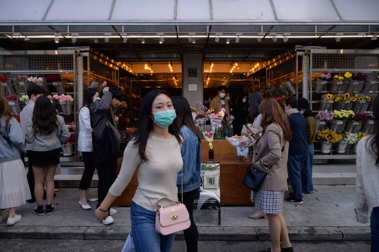 Mensen dragen een gezichtsmasker op straat in Yeonnam, Seoul.  Beeld AFP