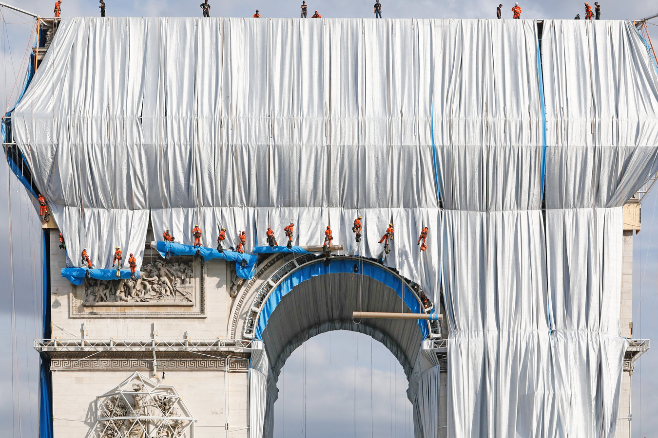 Phase finale de "l'empaquetage" de l'Arc de Triomphe avec 25 000 m² de tissu recyclable en polypropylène argent bleuté et 3000 mètres de corde rouge de la même matière