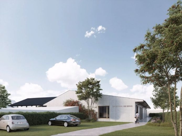 Een zicht op de nieuwe sporthal met vooraan de parking die onthard wordt.
