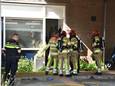 Brandweer en politie bij de woning, waarvan de deur geforceerd werd.