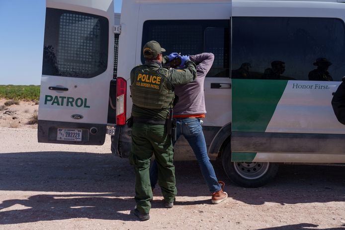 An immigrant who tried to cross the border illegally with a group was searched by a US Border Patrol agent.  Picture taken last week.