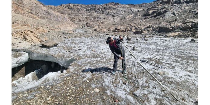 Measuring ice sticks on the Alpe d'Huez Glacier.