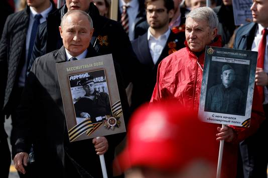 Putin with a portrait of his father, a war veteran.