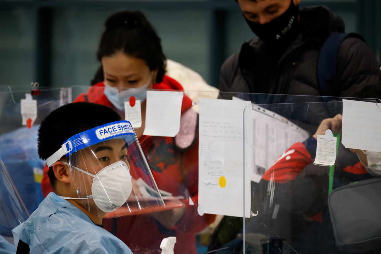 Een vrouw checkt aankomende passagiers op de internationale luchthaven van Incheon, Zuid-Korea. Beeld REUTERS