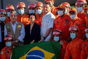 Bolsonaro (midden) en Braga Netteo (minister van Defensie, links in bodywarmer) met brandweermedewerkers