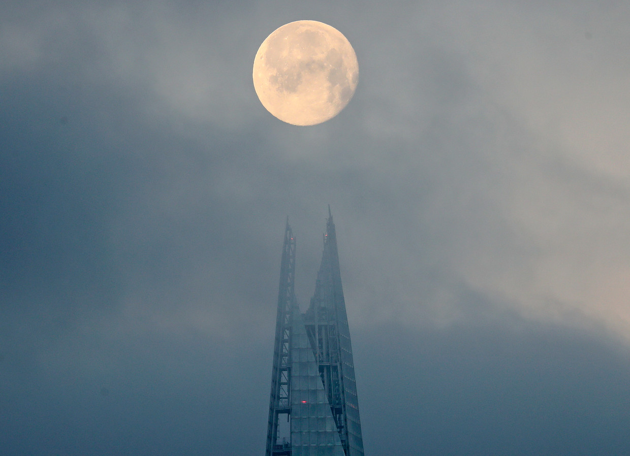 Full moon over a skyscraper in London.  AP photo