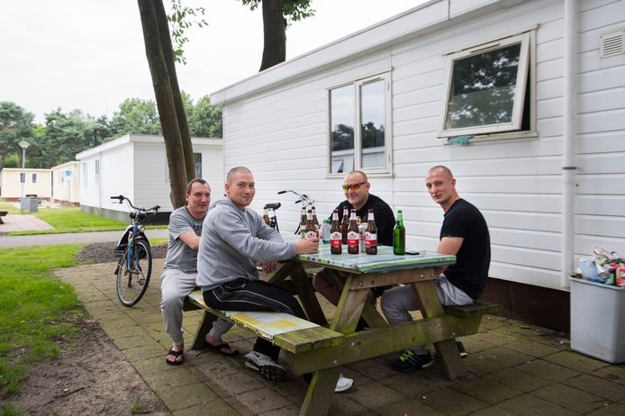 Poolse arbeidsmigranten bij hun woning op een recreatiepark in Oss, op een archiefbeeld uit 2006.