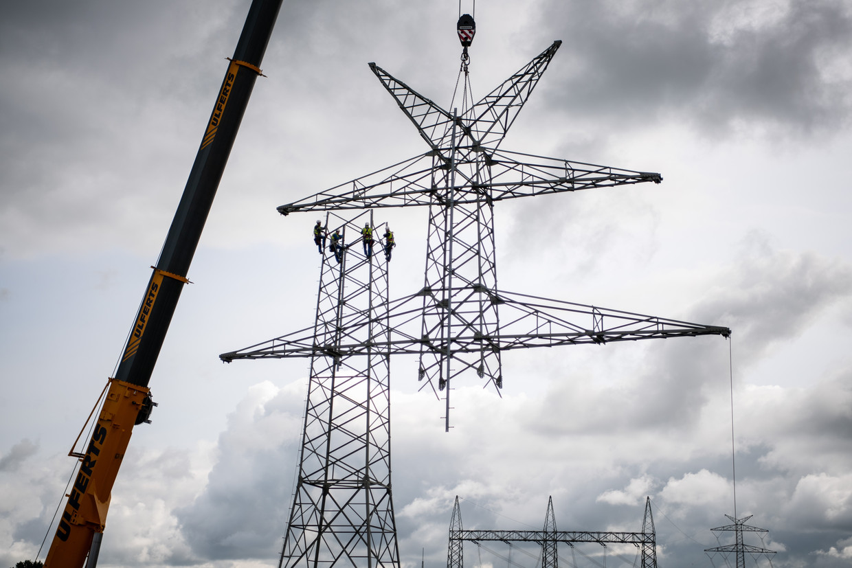 Een hoogspanningsmast in het Nedersaksische Bockhorn wordt ontmanteld. Vanwege het transport van windenergie wordt een nieuw netwerk aangelegd dat een extra hoog voltage aankan. Beeld ANP / dpa Picture-Alliance
